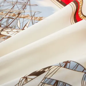 Detailed close-up of nautical sailboat print on premium beige twill silk scarf fabric