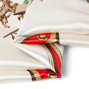 Close-up of ivory silk scarf showing satin texture and vintage horse emblem pattern