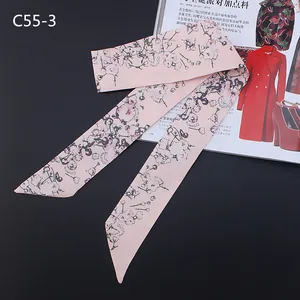 Close-up of pink floral silk scarf with cherry blossom print and pearl patterns
