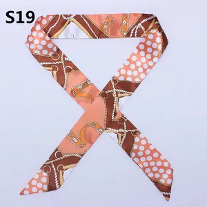 Narrow silk twilly scarf with chain pattern and dots in orange and brown tones