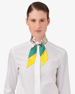 Silk-like polka dot Twilly scarf styled on a white shirt collar for elegant women