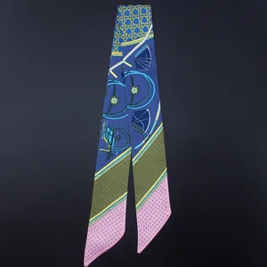 Close-up of geometric dot pattern on silk-feel twilly scarf with blue and pink panels