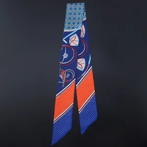 Close-up of narrow silk scarf featuring nautical motifs and orange contrast patterns