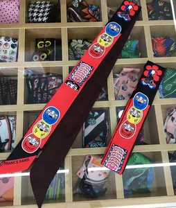 Set of two long silk twilly scarves with daruma patterns and vibrant floral prints