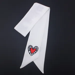 Elegant white satin scarf with red heart motif and spider patterns on black background