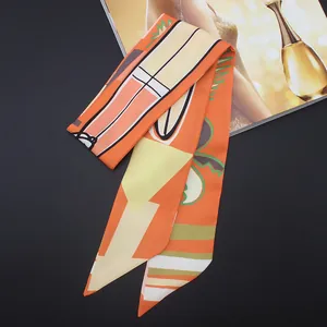 Orange twilly silk scarf with abstract leaf patterns for handbag handles and hair styling