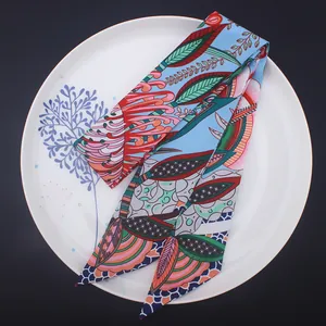 Bohemian floral pattern twilly silk scarf with bright tropical plants on blue background