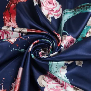 Detailed texture of dark blue satin silk scarf with pink rose and artistic ink prints