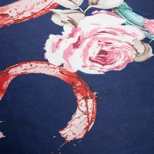 Macro shot of silk scarf showing realistic rose prints and artistic red circles