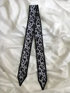 Classic leopard print silk twilly scarf 120cm for handbag handles on white satin background