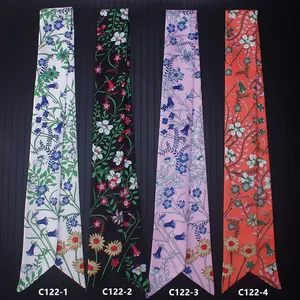 Vertical display of four floral twilly scarves in white black pink and orange colors