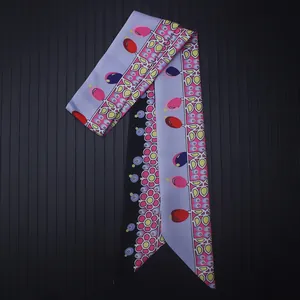 Close-up of floral print twilly scarf with pink flowers and geometric teardrop patterns
