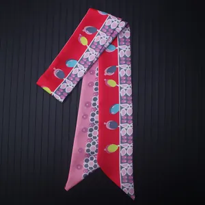 Detailed close-up of a double-sided floral satin twilly scarf for bags and hair