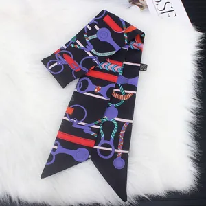 Detail of multi-color horse harness print silk scarf on plush white background