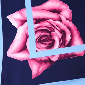 Detailed macro view of pink rose print on navy blue silk scarf with smooth texture