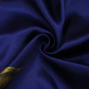Close-up of luxury dark blue satin scarf with silk-like sheen and floral pattern details