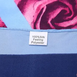 Detail of leaf and rose print scarf with 100% silk feeling polyester fabric tag