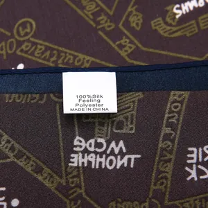 Detail view of the 100% silk feeling polyester scarf with stitched edges and retro print