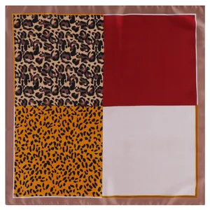 Macro detail of silk-like square scarf with leopard print and multi-color patchwork patterns