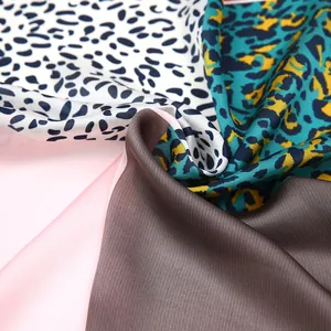 Close-up of leopard print satin scarf showing smooth texture and mixed pattern details