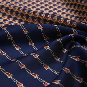 Detail of silk satin scarf with dark blue abstract chain patterns and smooth texture