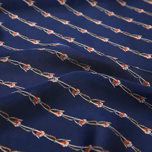 Detail of silk-like satin fabric with vintage navy chain print and glossy texture