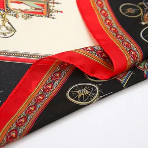 Detail of a silky square scarf featuring vintage carriage print with a red border