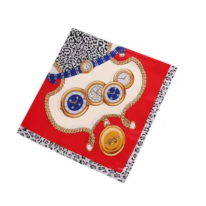 Detail of red square silk scarf featuring leopard print borders and gold watch patterns
