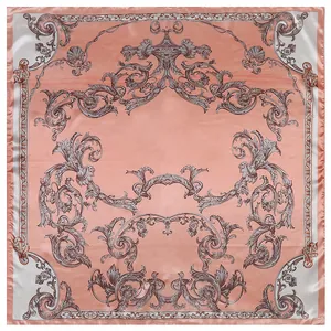 Macro view of European baroque patterns on coral pink silk scarf with satin finish