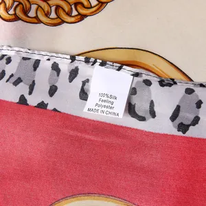 Macro shot of product label showing 100% silk feeling polyester and detailed fabric texture