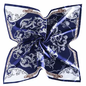 Macro detail of navy blue baroque silk scarf with vintage ornate scroll patterns