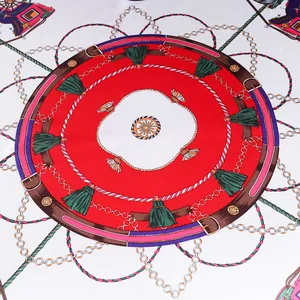 Detailed pattern of a square silk scarf with red equestrian tassel and belt design