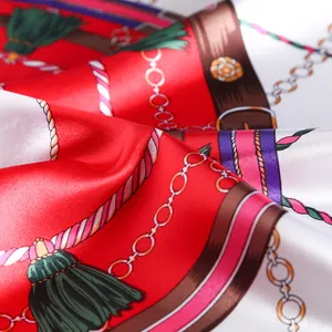 Macro shot of silk scarf fabric showing elegant satin gloss and retro tassel patterns