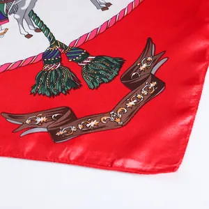 Detail of silk-satin scarf featuring carousel horses and vibrant tassel patterns