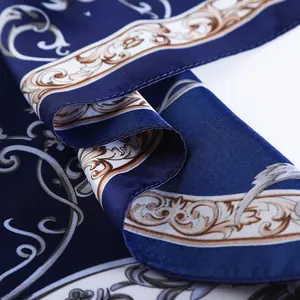 Macro detail of silk scarf with baroque pattern and premium satin texture in dark blue