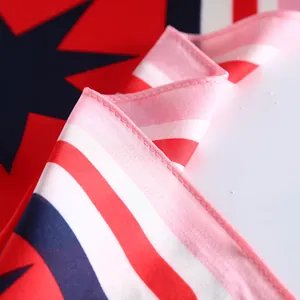 Macro shot showing the red and blue geometric star pattern and pink overlock stitching