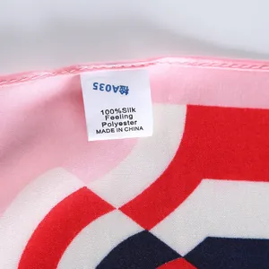 Macro view of a 100% silk feeling polyester scarf label with refined twill fabric texture