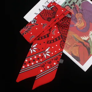 Red twilly silk scarf with stars and polka dots pattern on a black artistic background