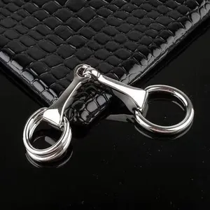 Boucle mors de cheval en métal argenté poli sur cuir noir avec relief crocodile