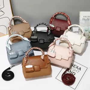 Detail of square bags in seven colors with silk-wrapped handles and adjustable straps