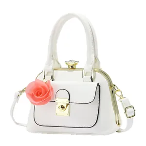 White contrast shoulder bag with gemstone clasp and decorative rose flower pendant