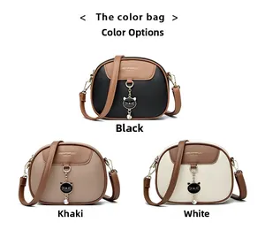 Three round crossbody bags in black, khaki, and white featuring cute cat charms and gold metal hardware