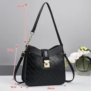 Detailed view of black quilted woven shoulder bag with size dimensions and gold lock