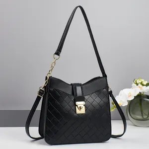 Elegant black quilted shoulder bag with gold twist lock and chain strap on minimalist background