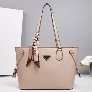 Elegant beige pebbled leather tote bag with silk scarf and metallic logo plate
