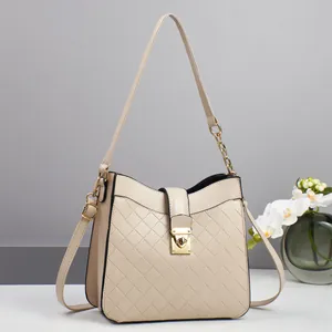 Quilted cream crossbody bag with gold chain handle and metallic lock for elegant women