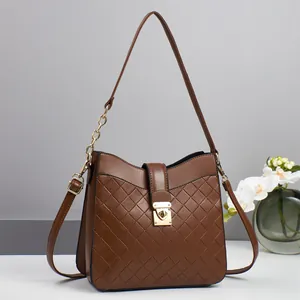 Deep brown quilted crossbody bag with gold hardware and woven design for women