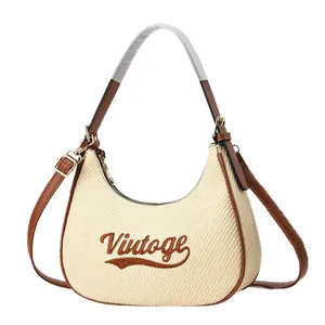 Minimalist crescent shoulder bag in beige woven fabric and brown leather trim