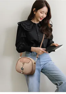Chic brown soft leather small round bag crossbody style with a cute cat pendant
