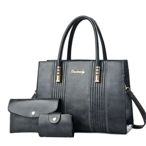 Three-piece black matte tote bag set with golden hardware and matching wallets